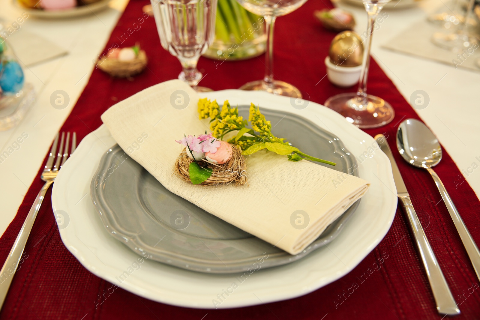 Photo of Festive Easter table setting with decorated eggs, closeup