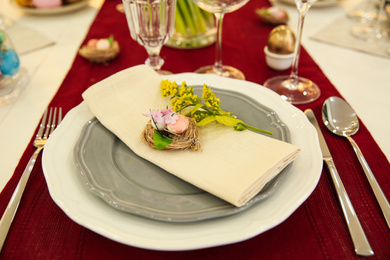 Photo of Festive Easter table setting with decorated eggs, closeup