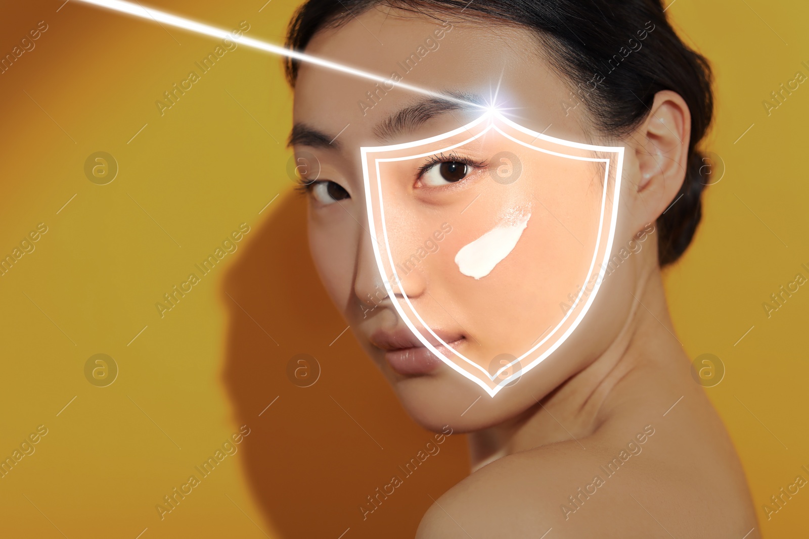 Image of Sun protection care. Beautiful woman with sunscreen on face against golden background. Illustration of shield as SPF