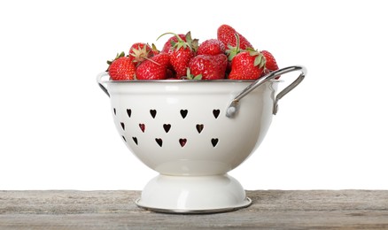 Photo of Colander with fresh strawberries on wooden table against white background