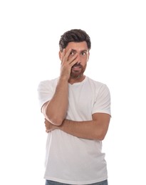 Embarrassed man covering face with hand on white background