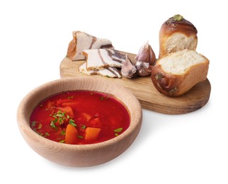 Photo of Delicious borsch served with pampushky and salo on white background. Traditional Ukrainian cuisine