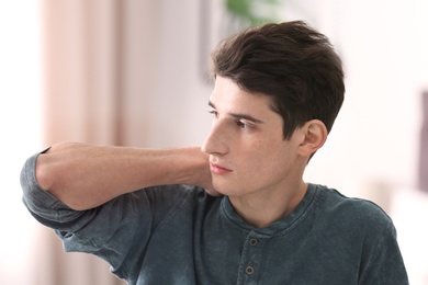 Photo of Portrait of young man with beautiful hair indoors