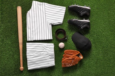 Flat lay composition with baseball equipment on artificial grass