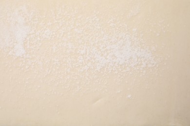 Raw puff pastry dough as background, top view