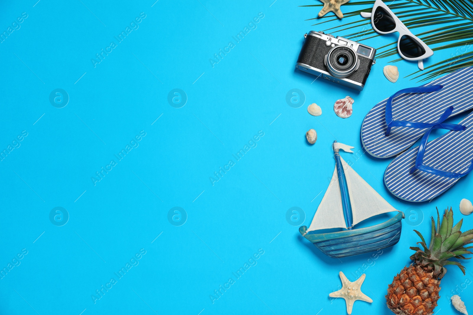 Photo of Flat lay composition with beach accessories on color background, space for text