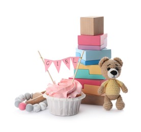 Photo of Baby shower cupcake with Girl topper near toys on white background