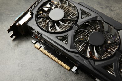 Photo of One computer graphics card on grey textured table, above view