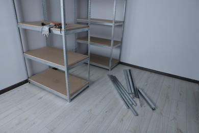 Photo of Metal storage shelf with room renovation tools in office
