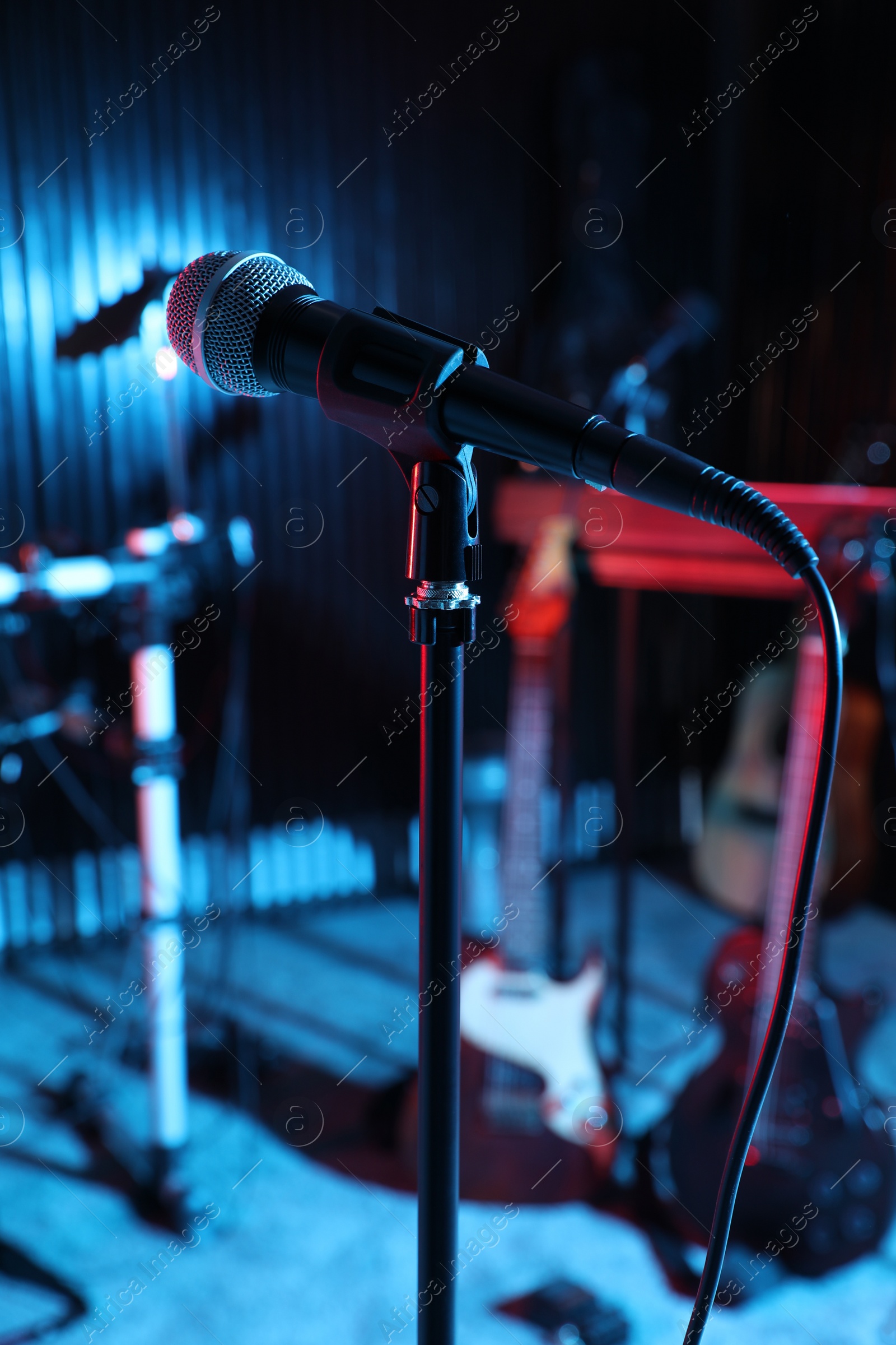 Photo of Modern microphone at recording studio, color toned. Music band practice