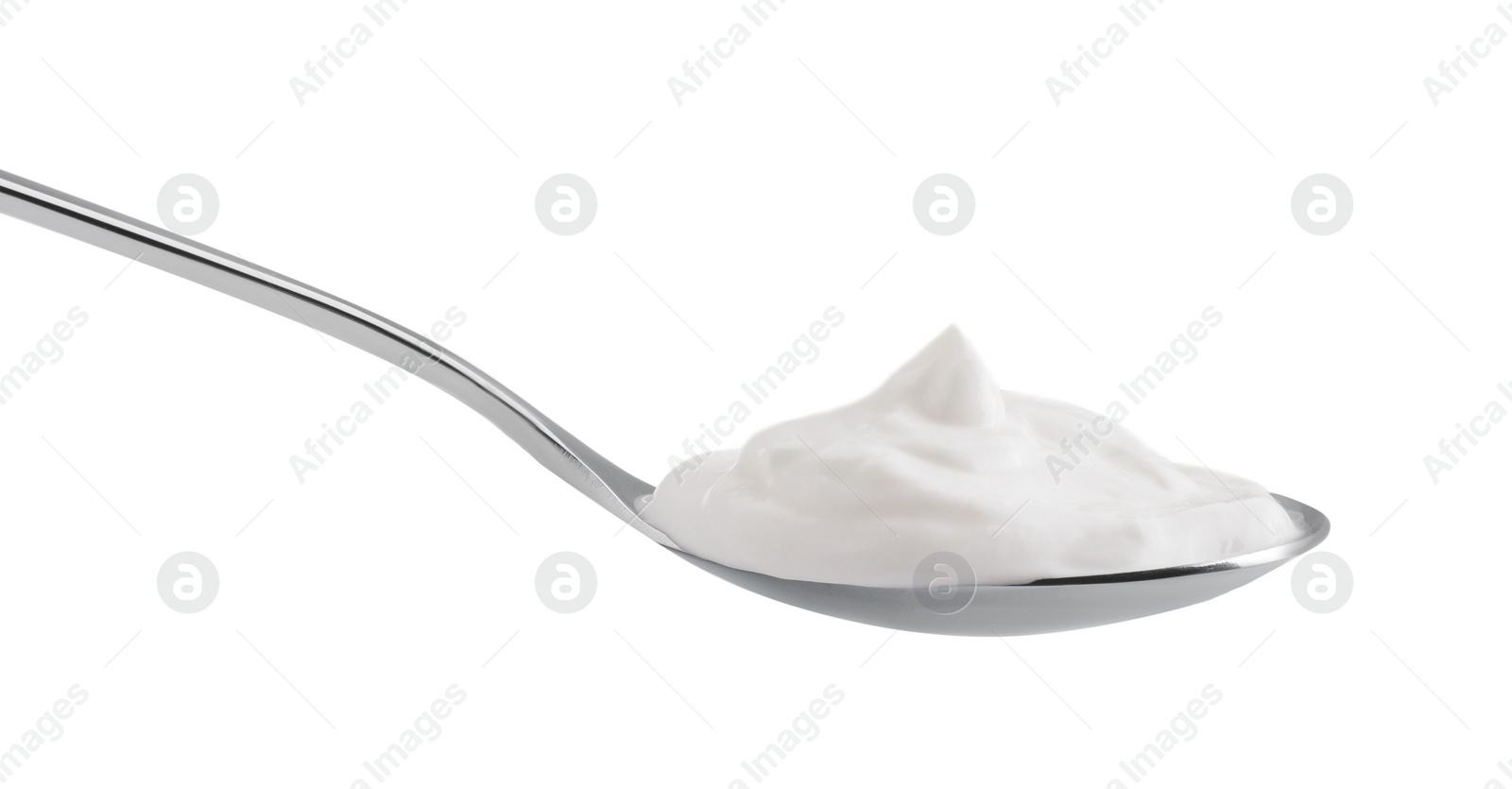 Photo of One silver spoon with sour cream isolated on white