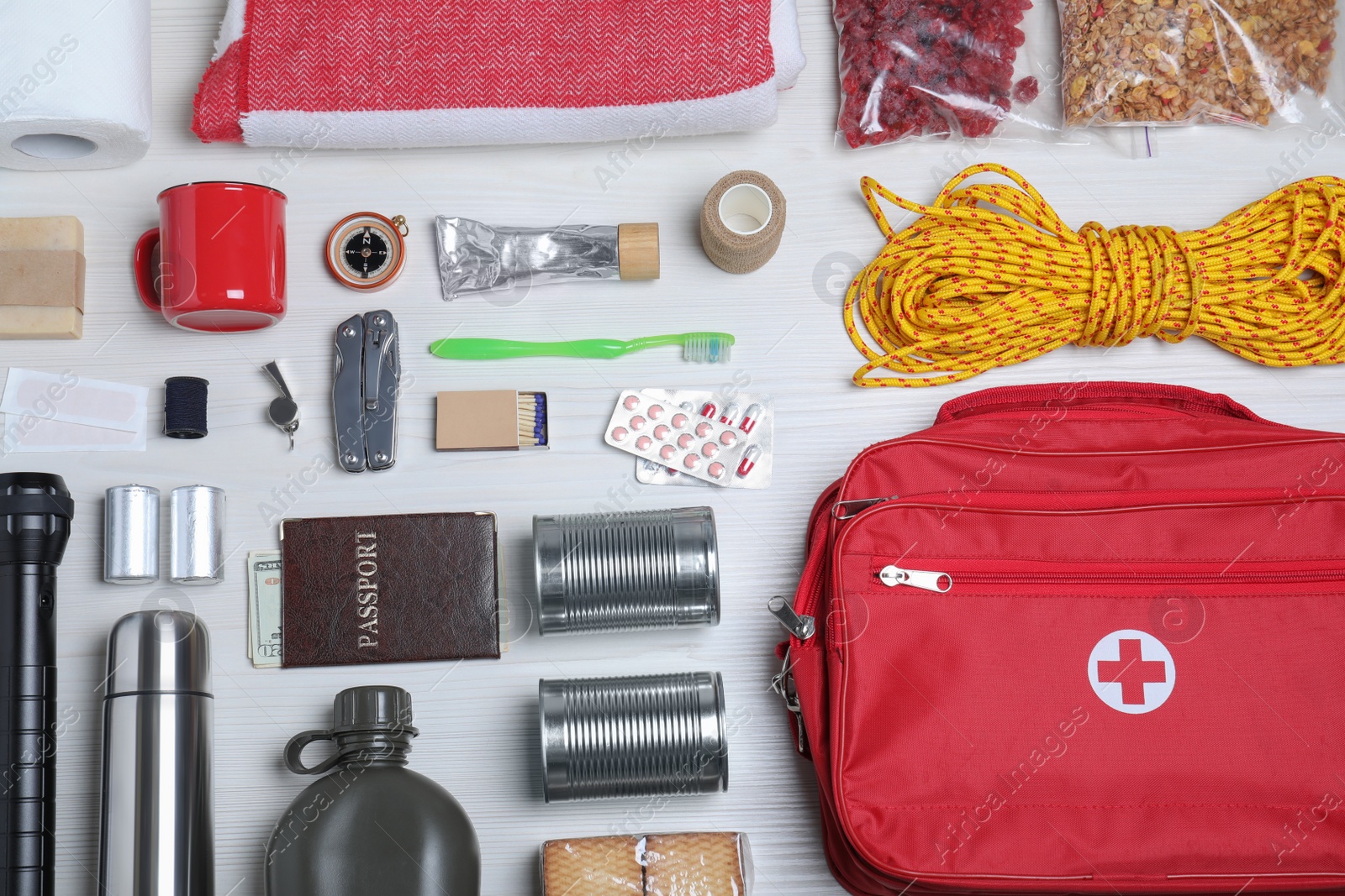 Photo of Disaster supply kit for earthquake on white wooden table, flat lay
