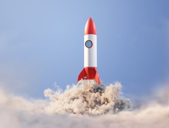 Image of Rocket with smoke flying in blue sky