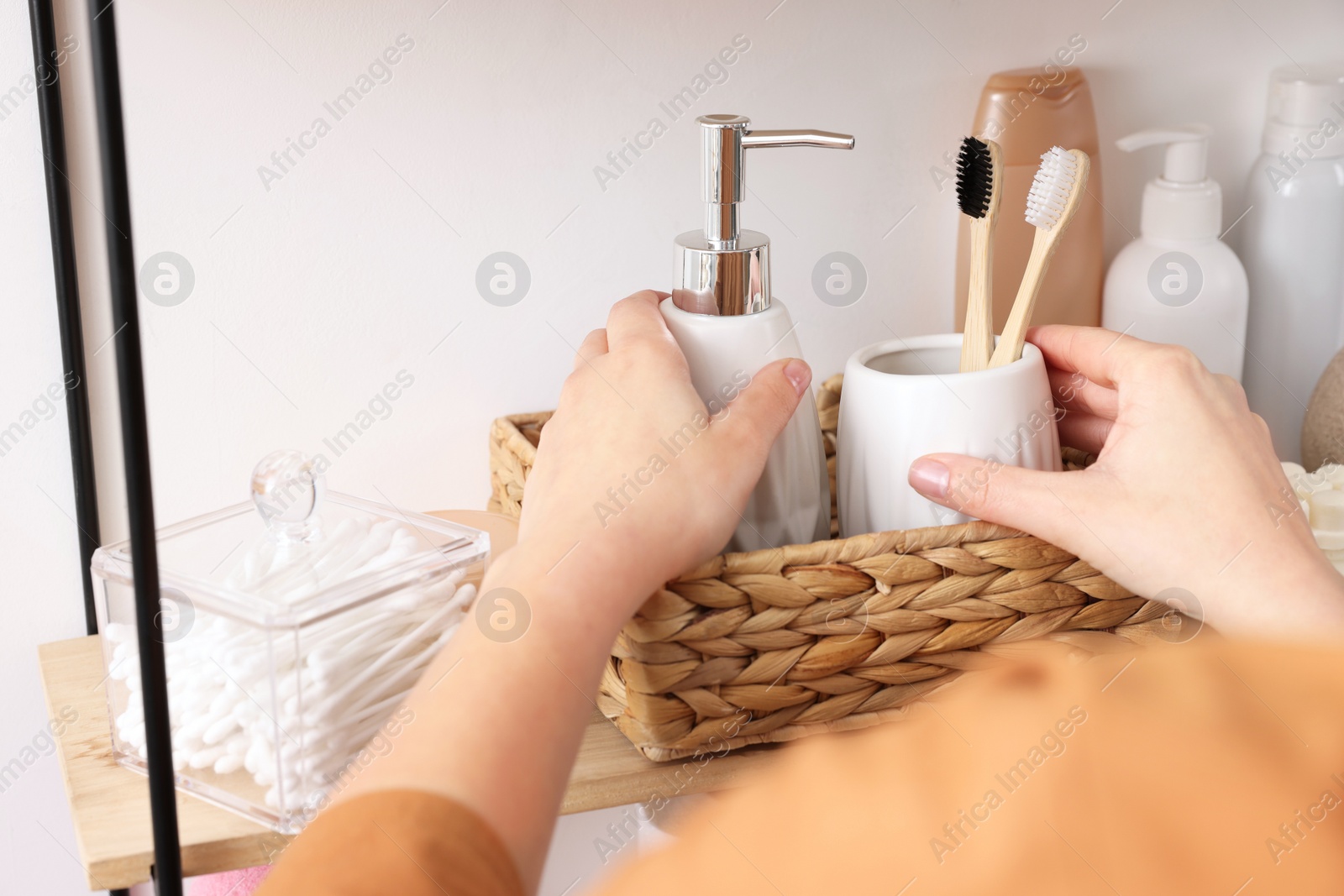 Photo of Bath accessories. Woman organizing personal care products indoors, closeup