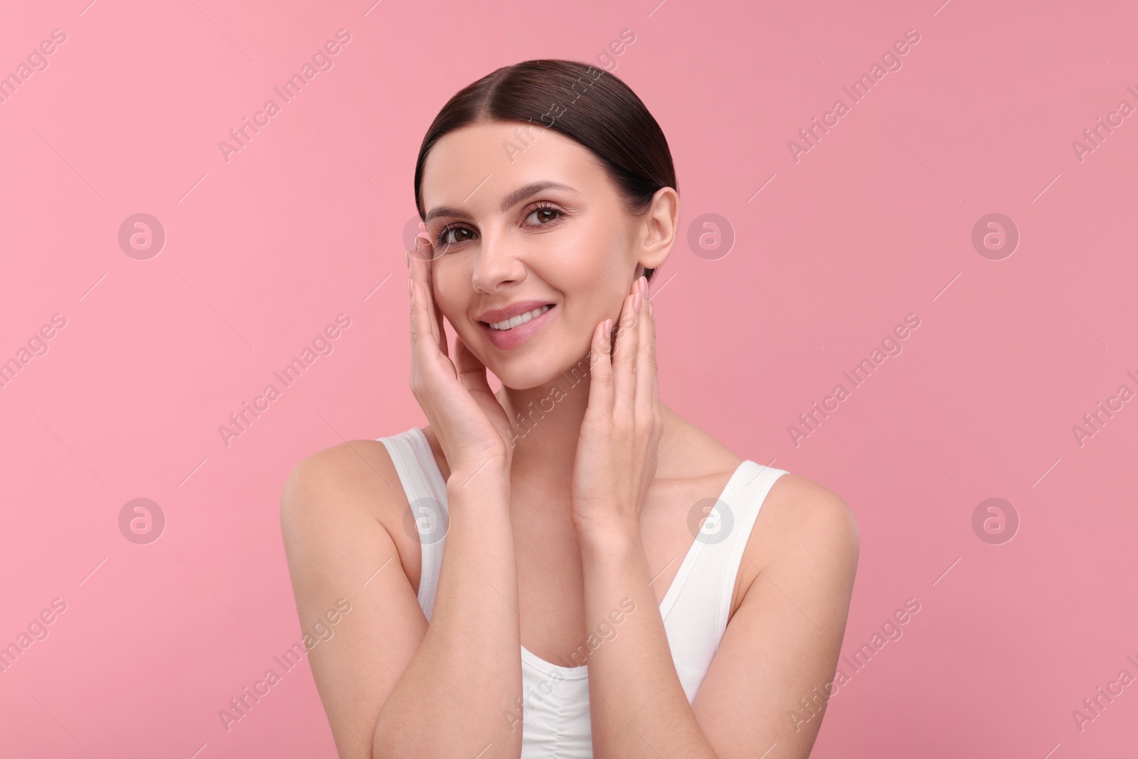Photo of Beautiful woman with healthy skin on pink background. Body Care