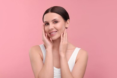 Beautiful woman with healthy skin on pink background. Body Care