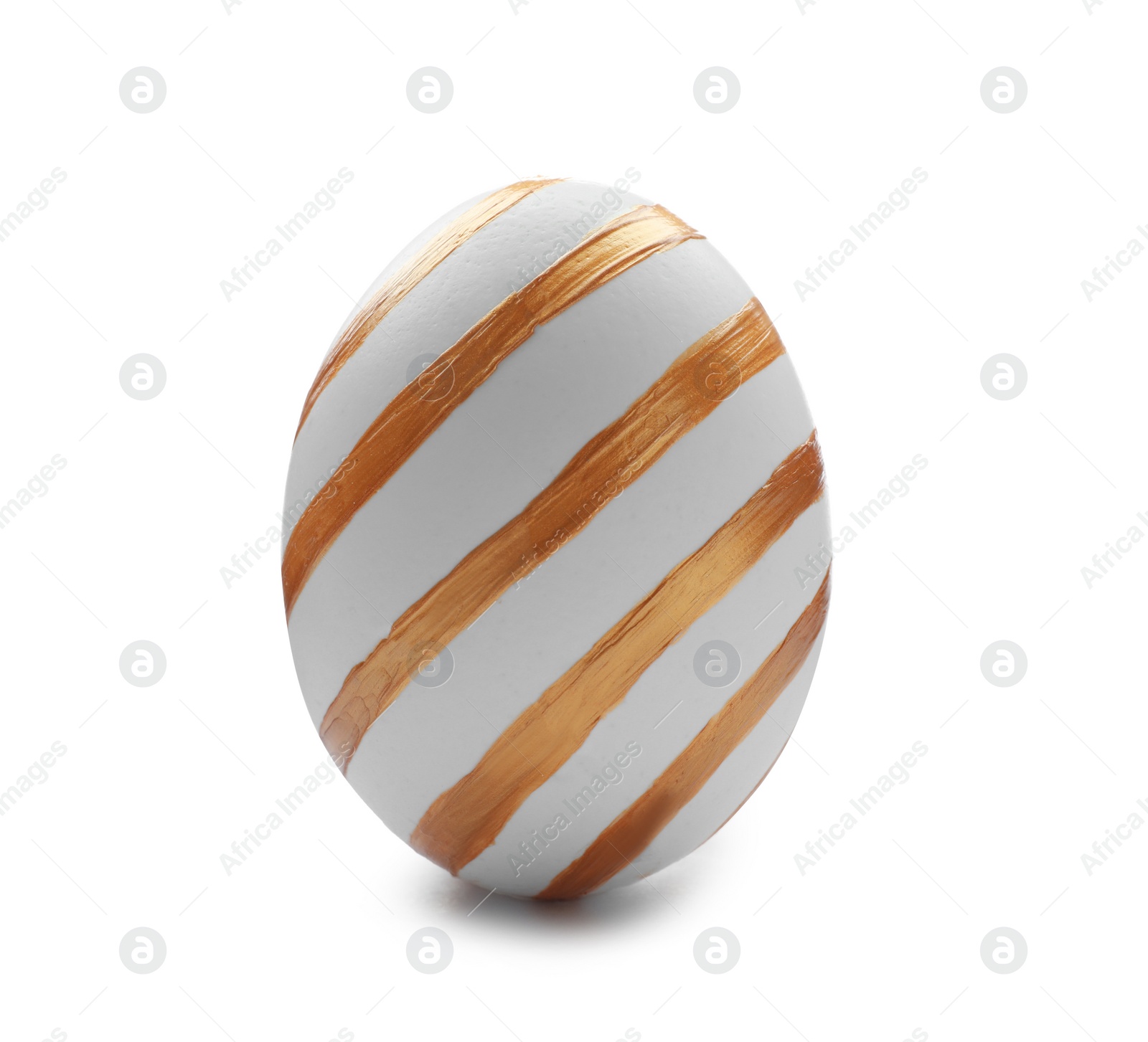 Photo of Traditional Easter egg decorated with golden paint on white background