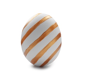 Traditional Easter egg decorated with golden paint on white background