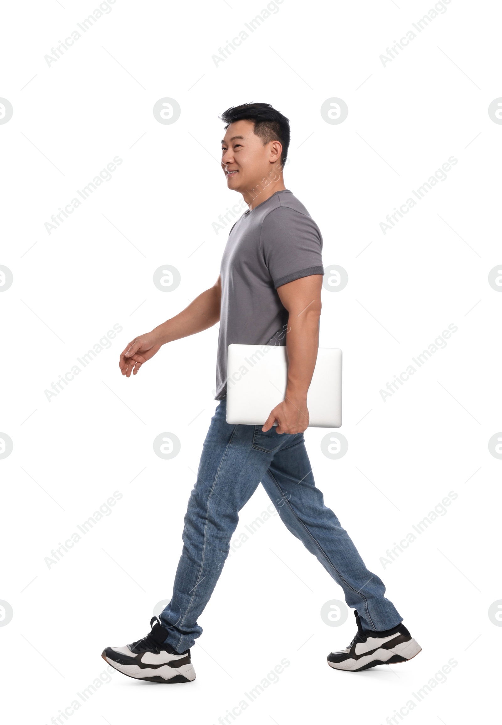 Photo of Man with laptop walking on white background