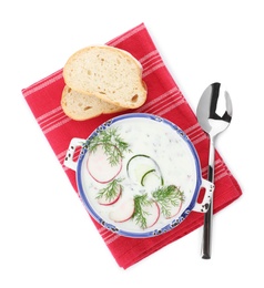 Delicious cold summer soup and bread on white background, top view