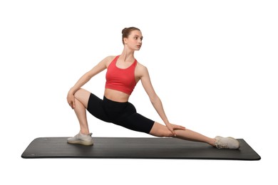 Yoga workout. Young woman stretching on white background