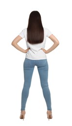 Woman wearing stylish light blue jeans on white background, back view