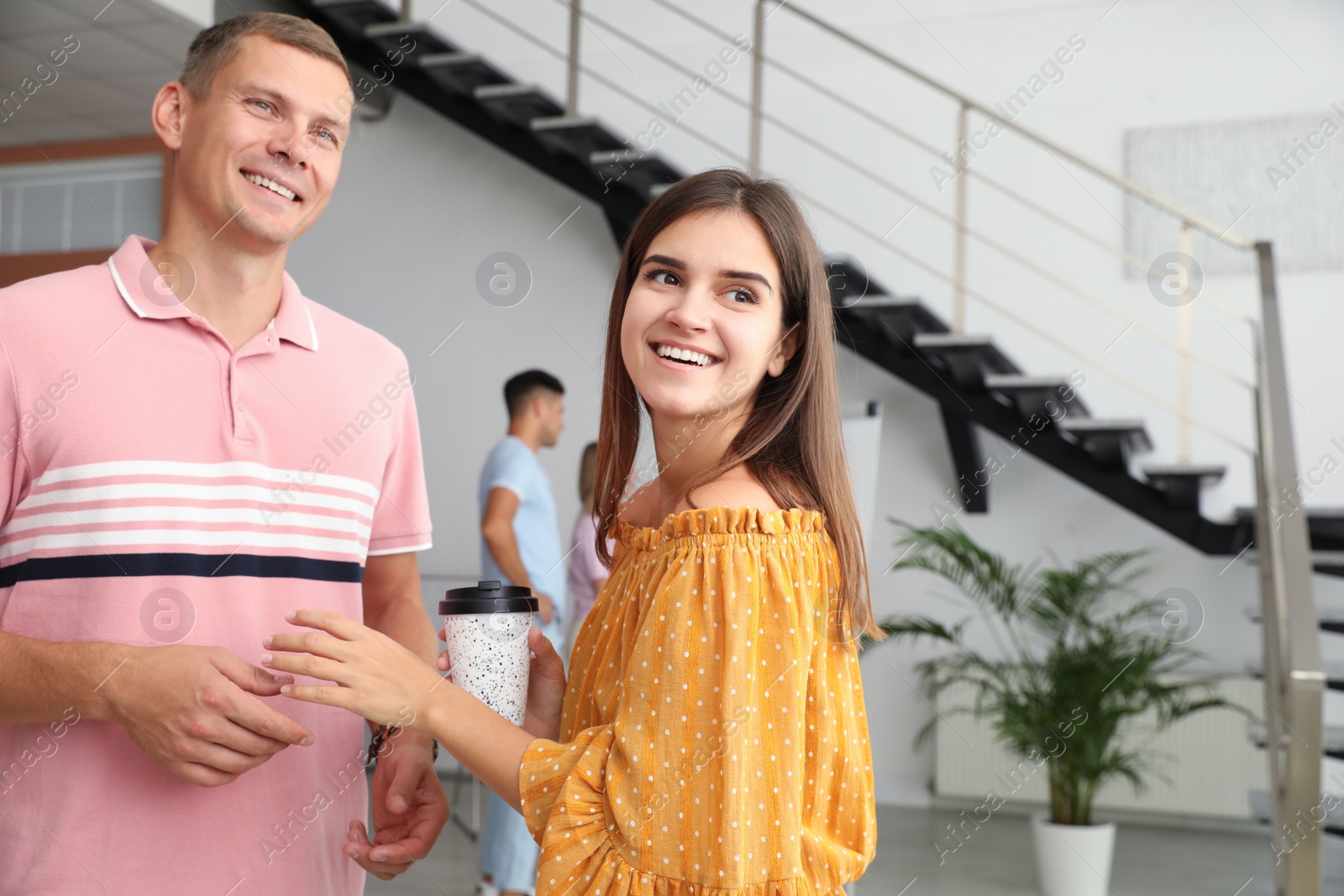 Photo of Man and woman having conversation in hall