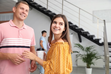 Photo of Man and woman having conversation in hall