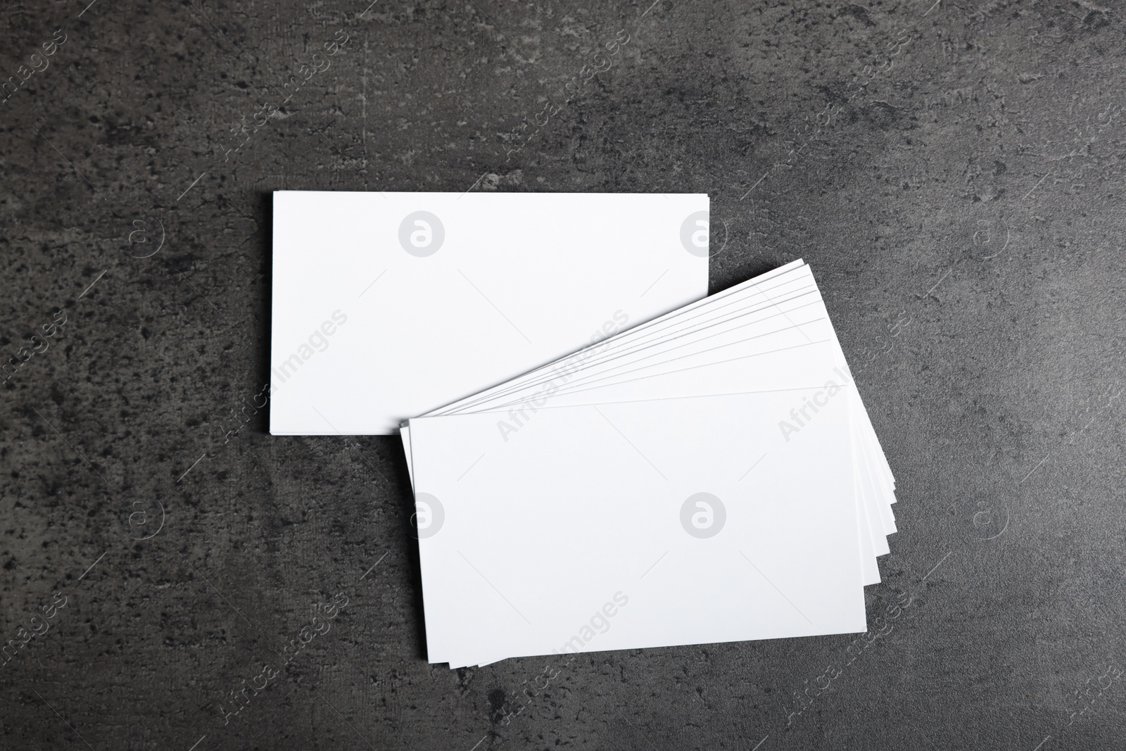 Photo of Blank business cards on grey textured background, top view. Mockup for design