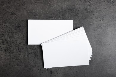 Blank business cards on grey textured background, top view. Mockup for design