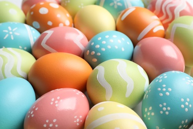 Photo of Many beautiful painted Easter eggs as background, closeup