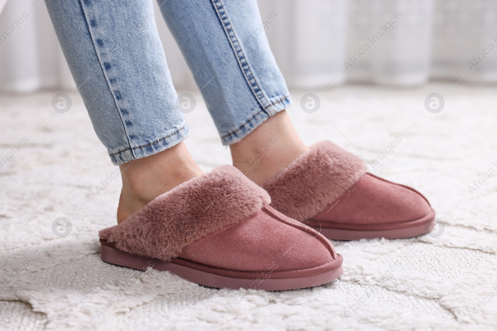 Photo of Woman in soft slippers at home, closeup