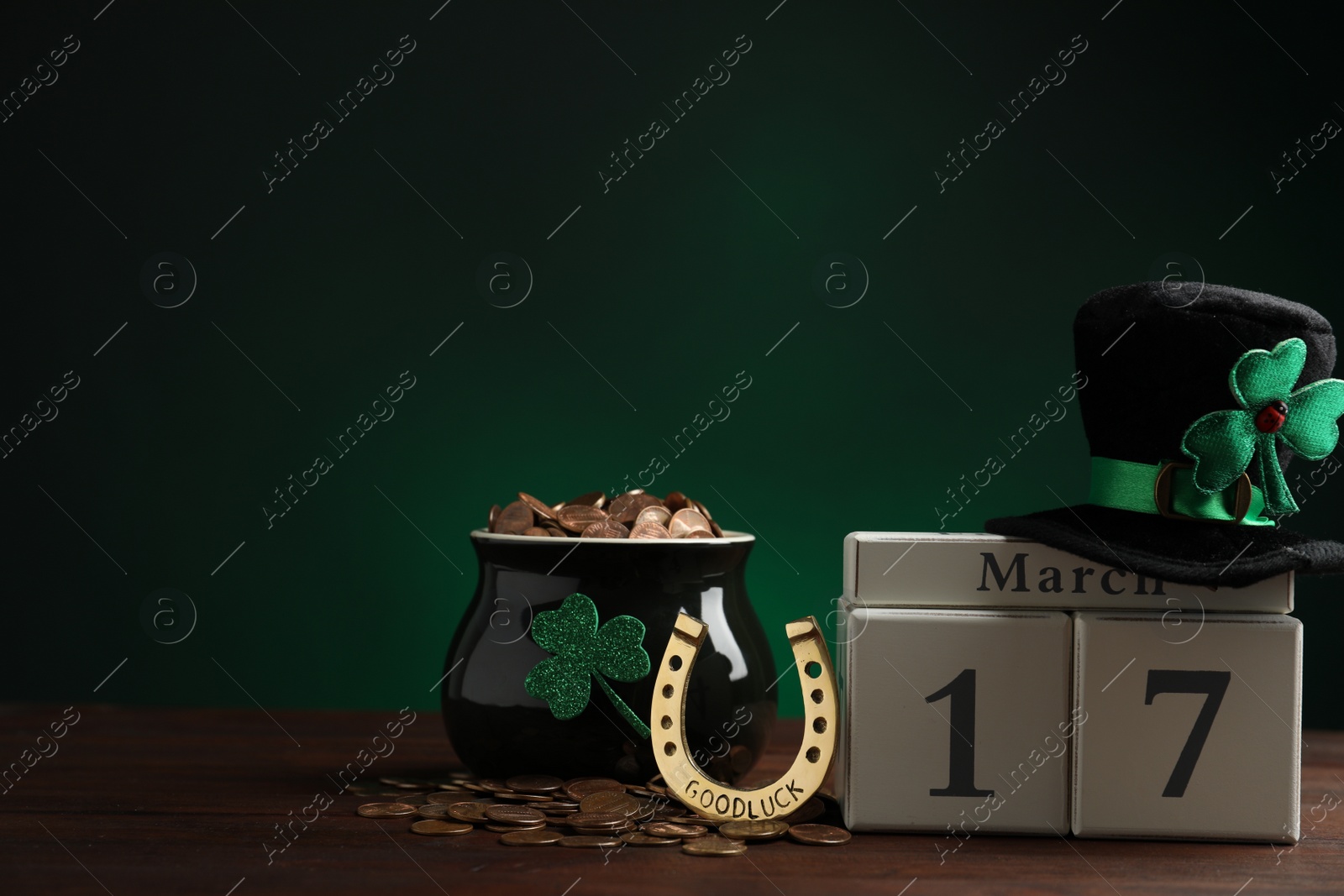 Photo of Composition with block calendar on wooden table, space for text. St. Patrick's Day celebration