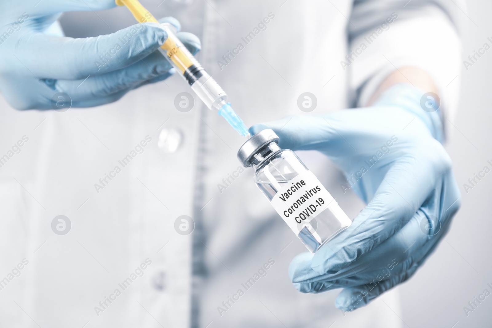 Image of Doctor filling syringe with coronavirus vaccine, closeup
