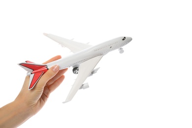 Woman holding toy airplane on white background, closeup