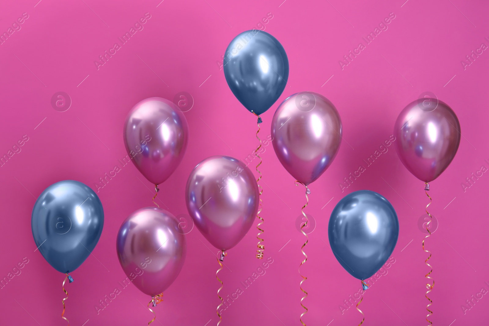 Photo of Bright balloons with ribbons on color background