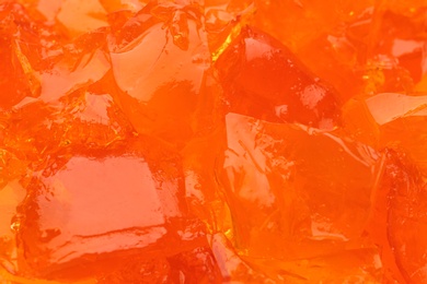 Photo of Orange tasty fruit jelly as background, closeup