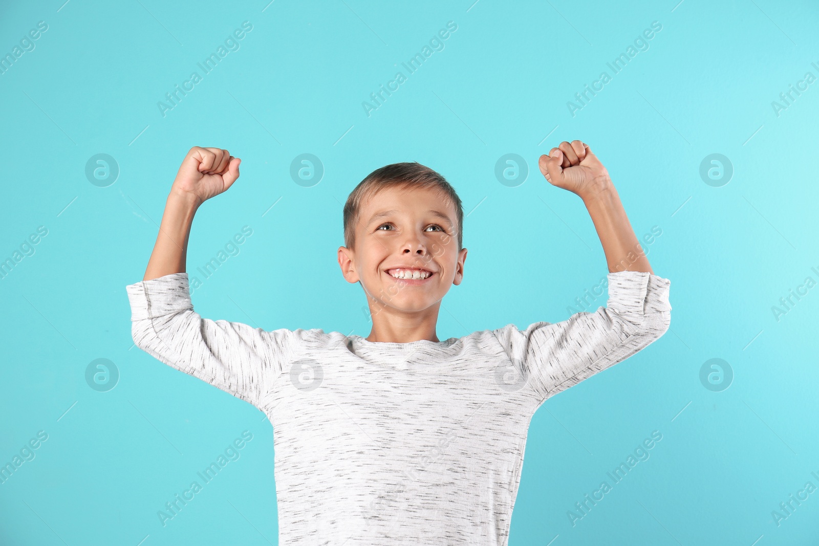 Photo of Adorable little boy in casual clothes on color background