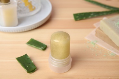 Photo of Natural crystal alum deodorant and aloe on wooden table