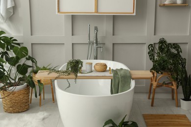 Photo of Stylish bathroom interior with green plants. Home design