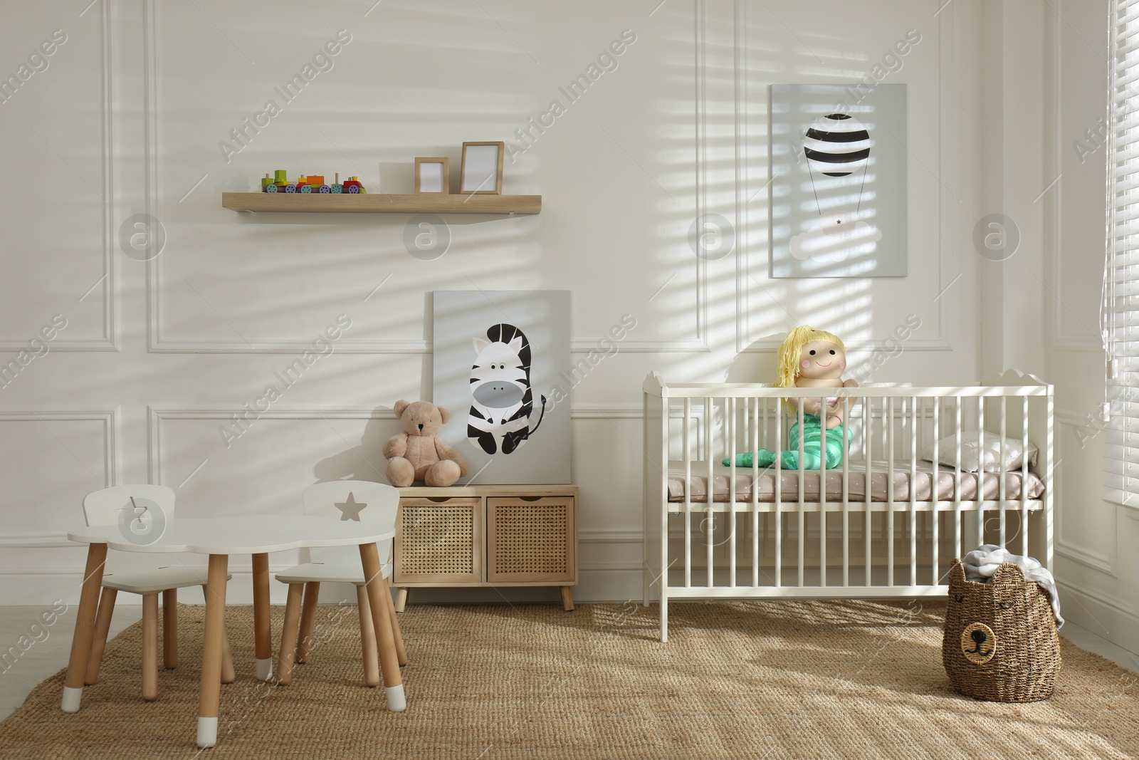 Photo of Light baby room interior with comfortable crib