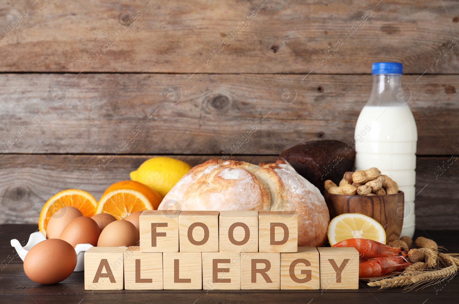 Photo of Different products on wooden background. Food allergy concept