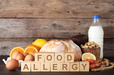 Different products on wooden background. Food allergy concept