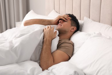 Photo of Handsome man lying in bed at home