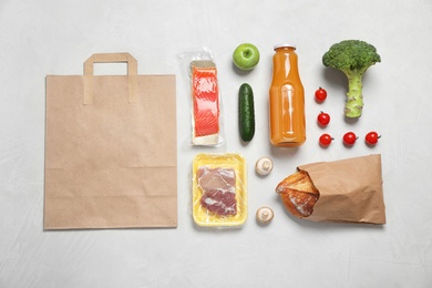 Photo of Fresh vegetables and other products on light grey background, flat lay