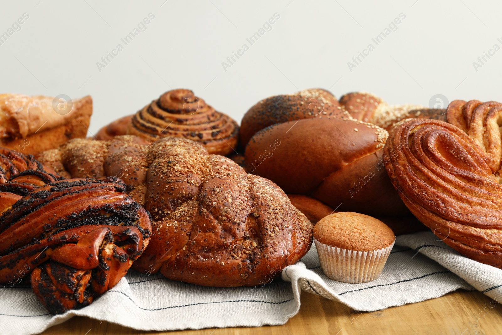 Photo of Different tasty freshly baked pastries on table