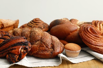 Different tasty freshly baked pastries on table