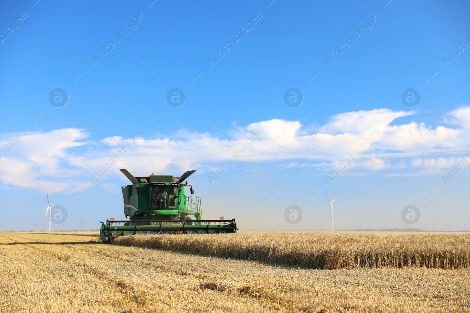 Photo of Modern combine harvester working in agricultural field