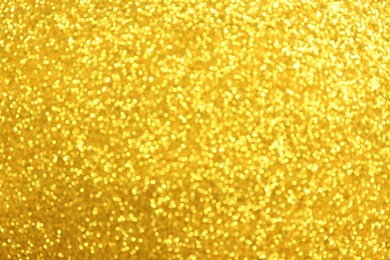 Beautiful golden shiny glitter as background, top view