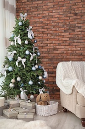 Decorated Christmas tree in stylish living room interior